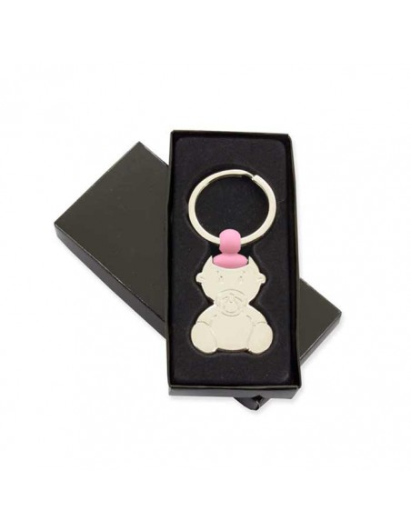 Llavero bebé con chupete y un detalle rosa, en su caja de presentación.